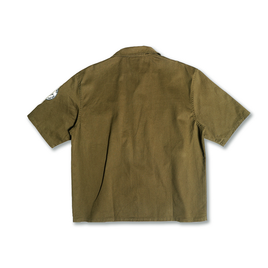 Olive drab short-sleeve overshirt, back yoke and button placket, patch detail at sleeve