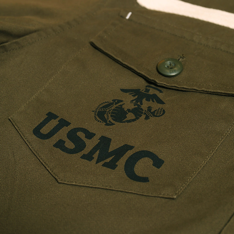 Olive drab chest pocket with USMC patch and green snap button