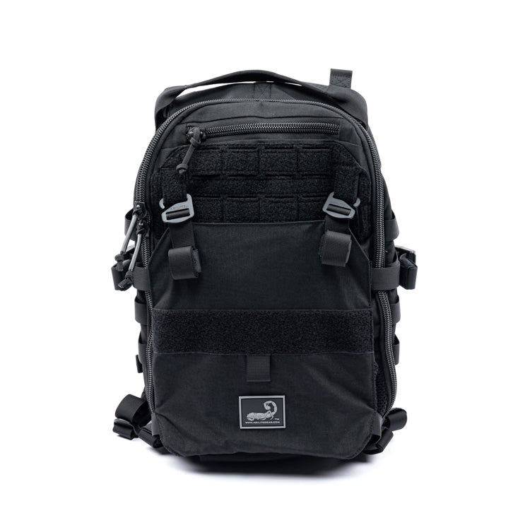 Black assault pack with front MOLLE panel, zip pocket, and shoulder straps