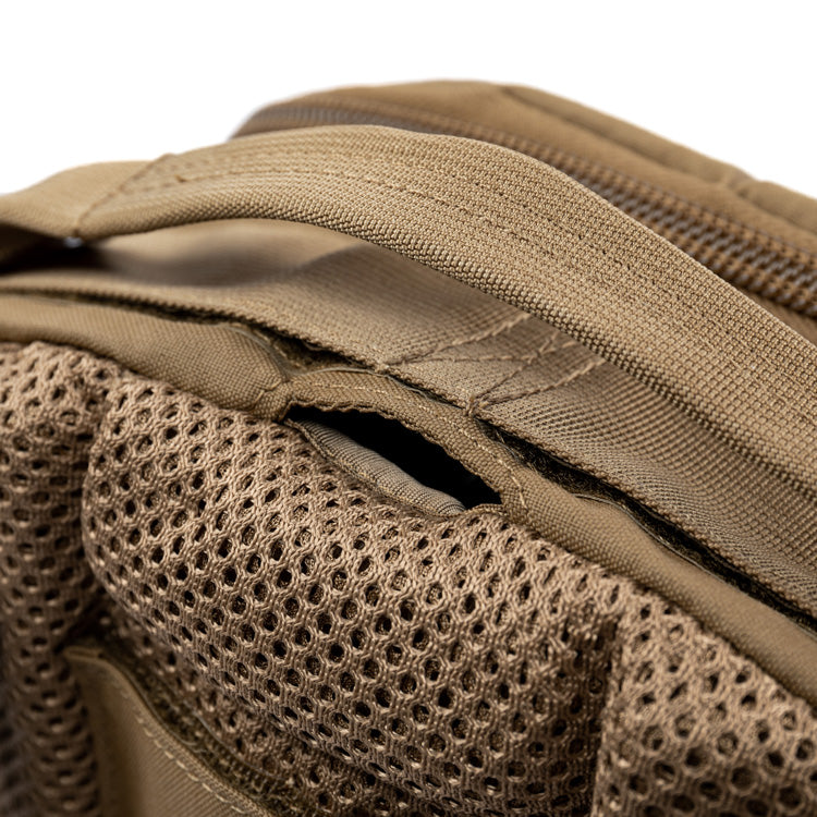 Tan assault pack strap area with ventilated mesh panel and stitching