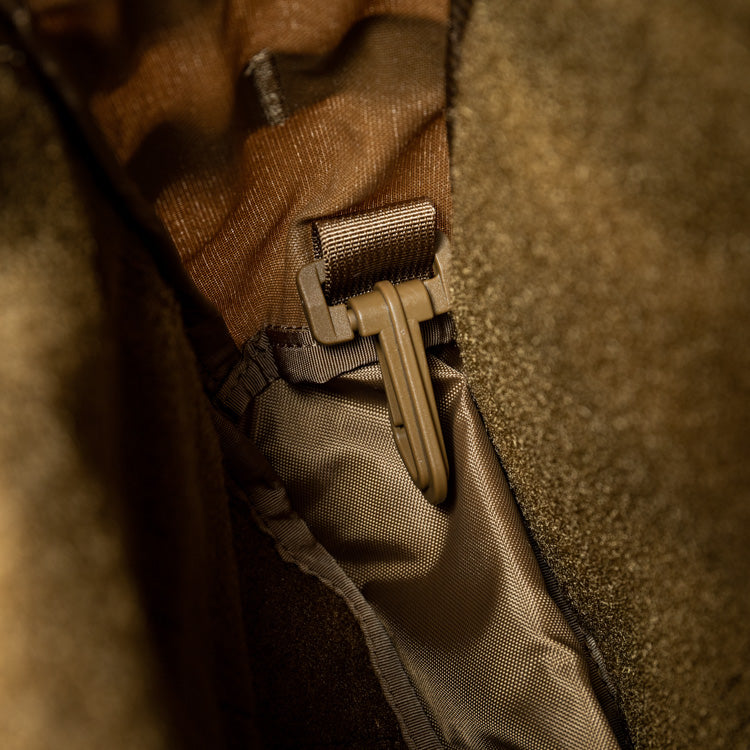 Tan assault pack pocket with mounted webbing clip and zipper pull