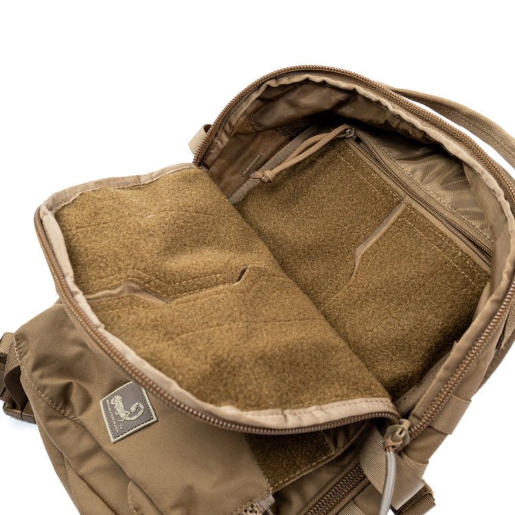 Tan assault pack interior with padded panels and front zipper compartment