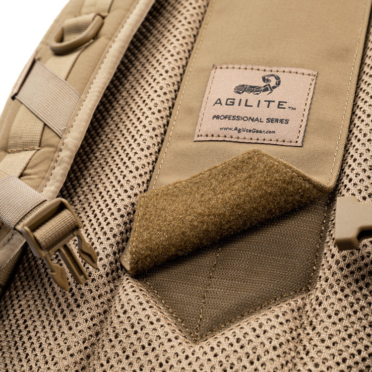 Tan assault pack back with AGILITE label and suede-style Velcro patch