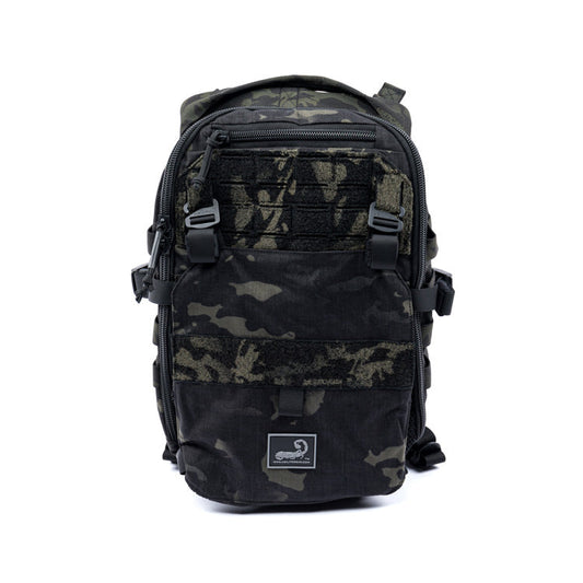 Multicam black assault pack with front zip pocket and MOLLE webbing straps
