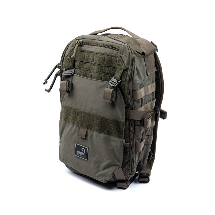 Olive assault backpack with front patch, MOLLE straps, and zippered side pockets