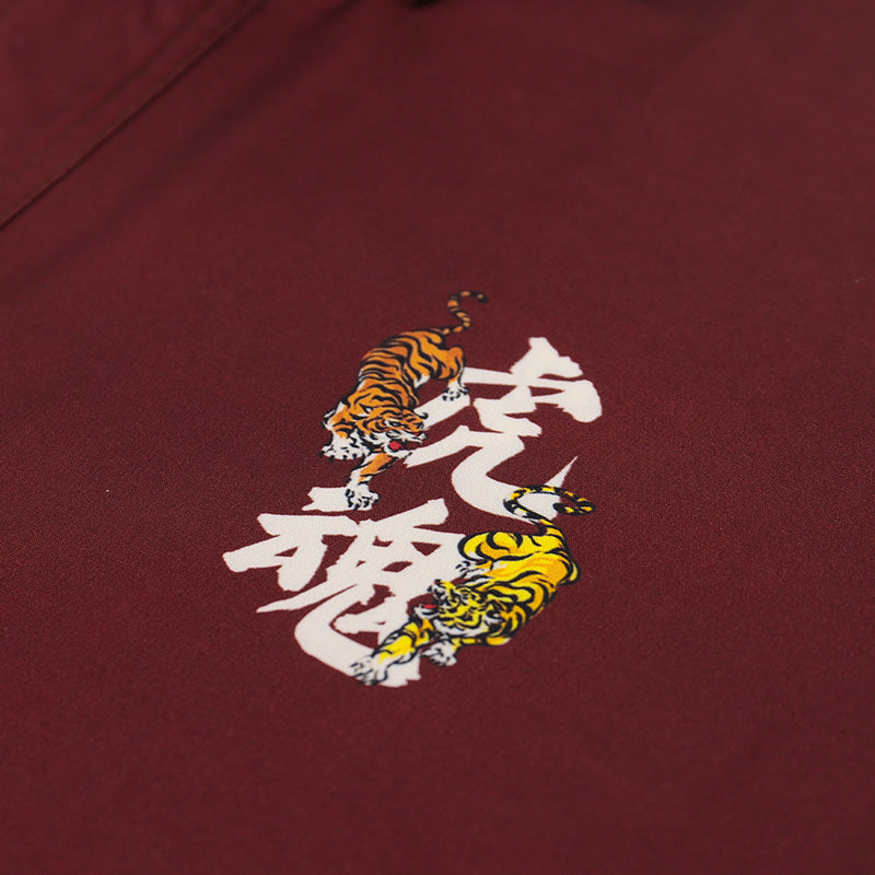 Burgundy resort shirt close-up, small tiger graphic on chest