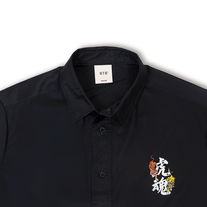 Black resort shirt close-up, small tiger emblem on left chest