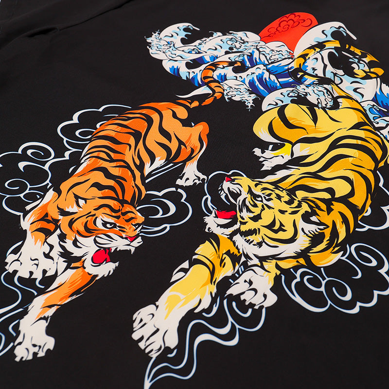 Black resort shirt close-up, tiger duo artwork with orange, blue, yellow details